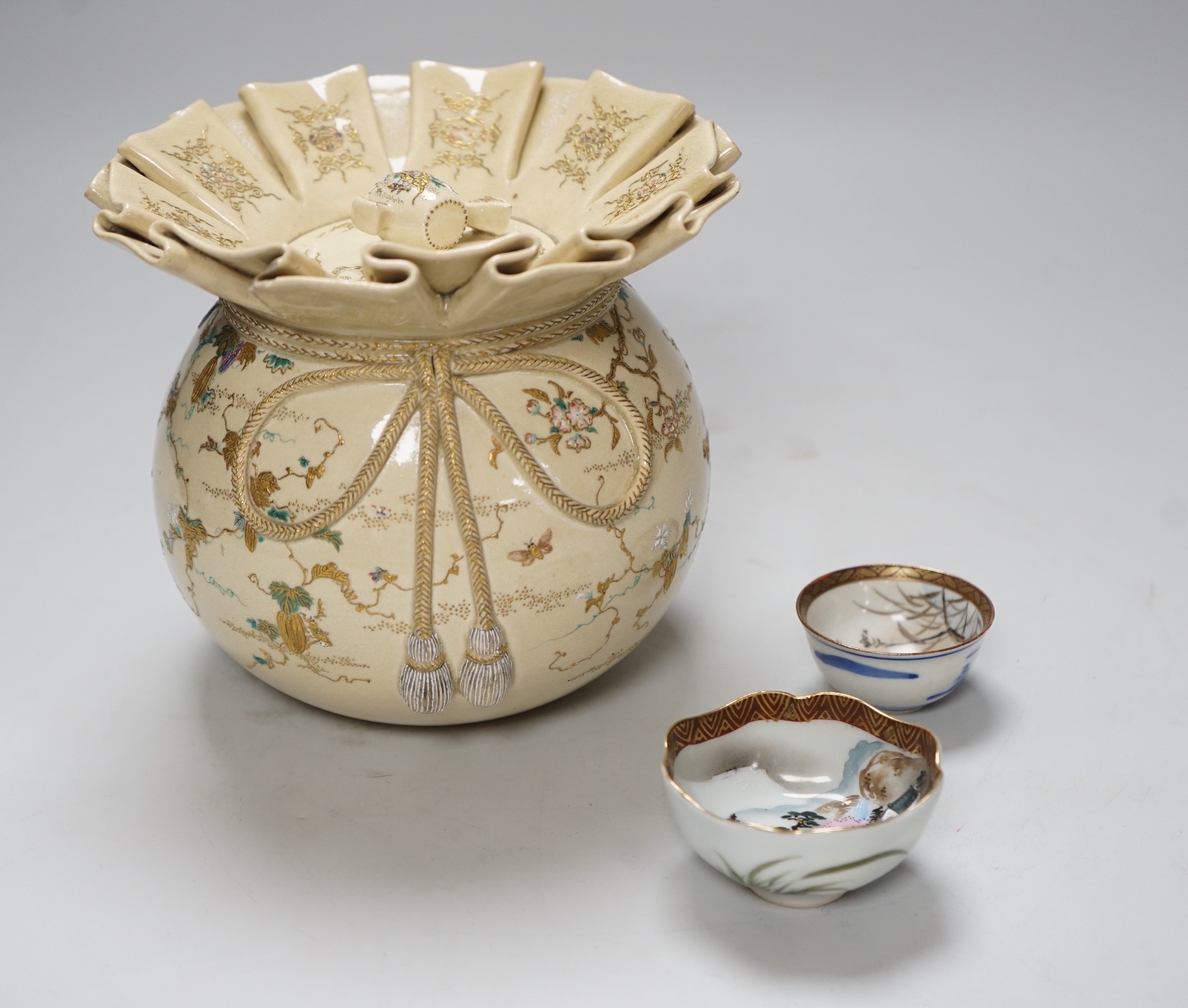 A Japanese Satsuma pottery jar and cover, Meiji period in the form of Daikoku's sack, together with two Kutani cups, tallest 14.5cm